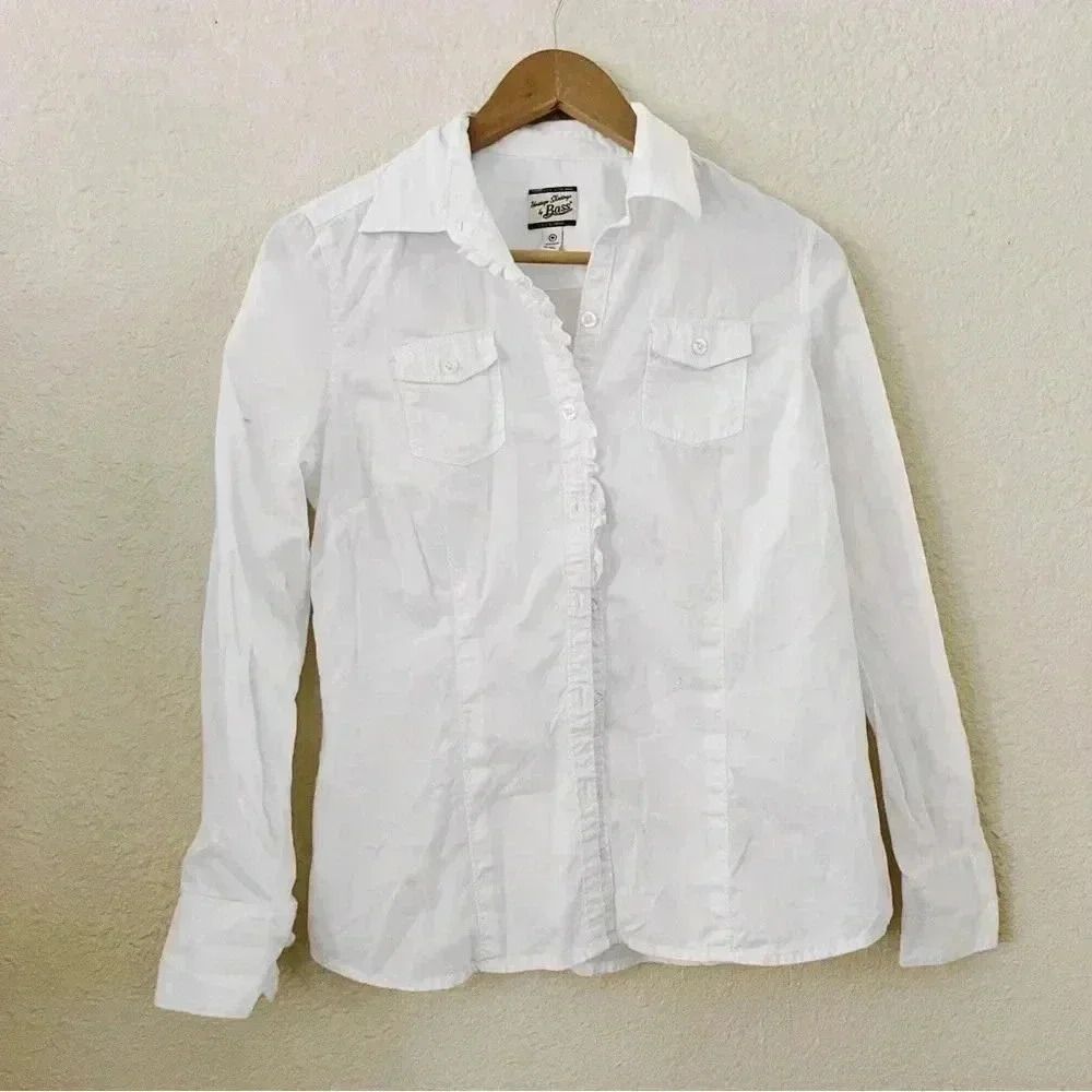 White top with ruffle detail on the sleeves and the button down